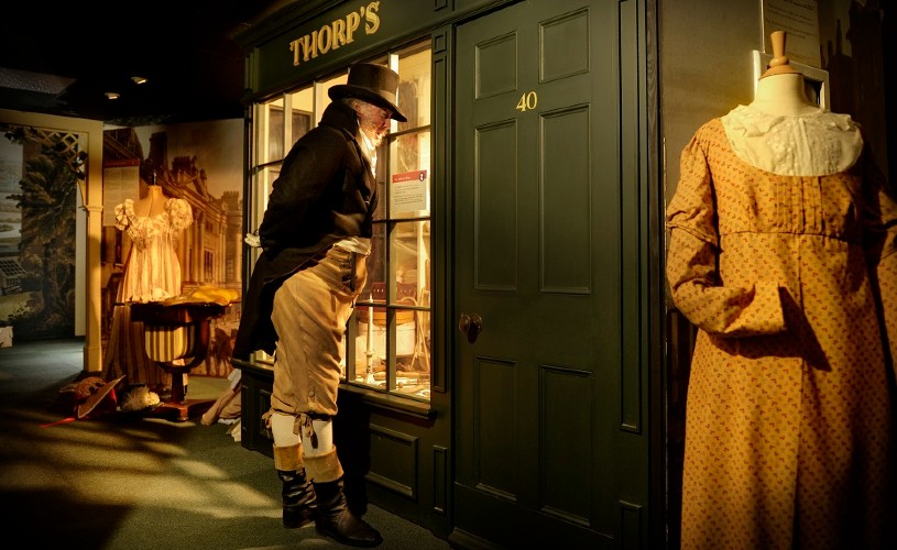Man in period costume looking at exhibit at Jane Austen Centre